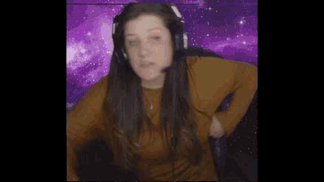 a woman wearing headphones and a necklace with a purple background