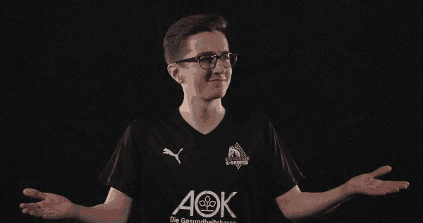 a young man wearing a black shirt with the word aok on it