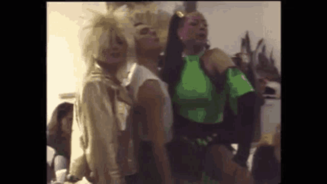 a group of people are standing next to each other in a room and dancing .