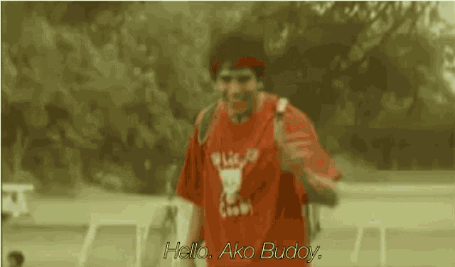 a man wearing a red shirt that says " hello ako buddy "