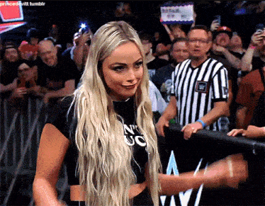 a blonde woman wearing a black shirt that says n ' uc on it