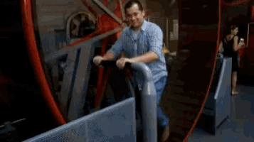 a man in a plaid shirt is riding a bike