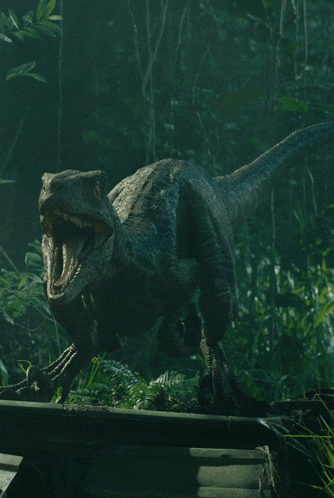 a dinosaur with its mouth open is walking through a dark forest