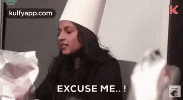 a woman wearing a chef 's hat is sitting on a couch and says `` excuse me ... '' .