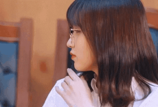 a close up of a woman 's face with glasses on .