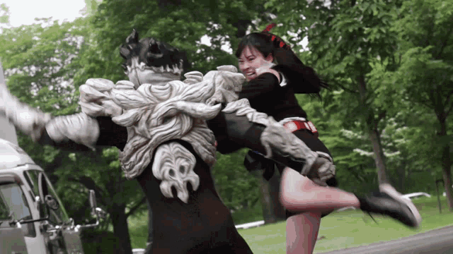a woman is kicking a monster with a sword
