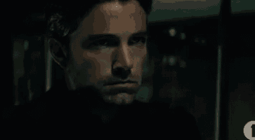 a close up of a man 's face with a serious look on his face .