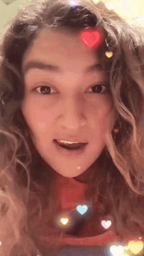 a close up of a woman 's face with hearts around her head