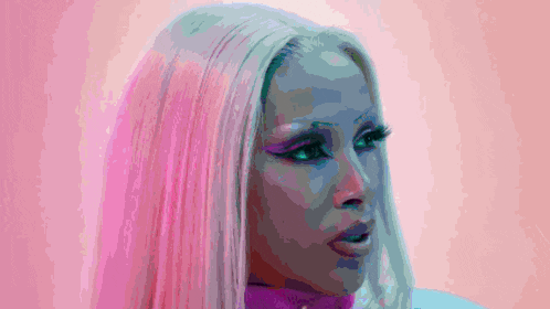 a close up of a woman 's face with pink hair and blue eyes