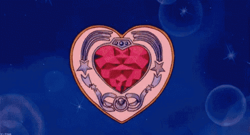 a woman 's hand is holding a heart shaped item .