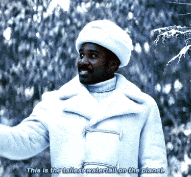 a man wearing a white coat and hat says " this is the tallest waterfall on the planet "