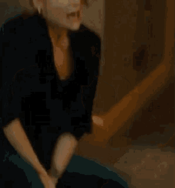 a woman is making a funny face while sitting on a chair .