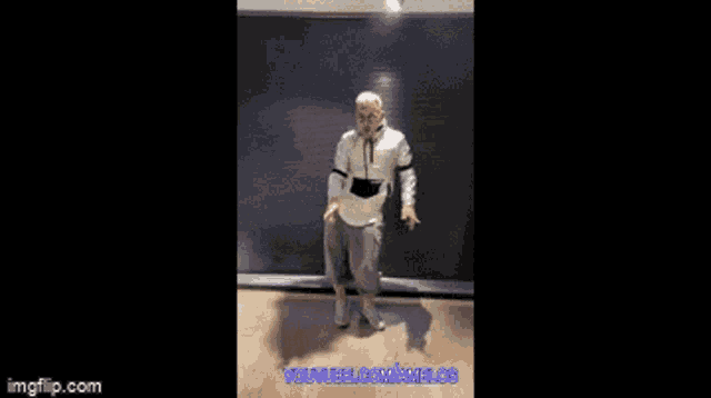 a man is dancing in a room with youtube.com written on the bottom right