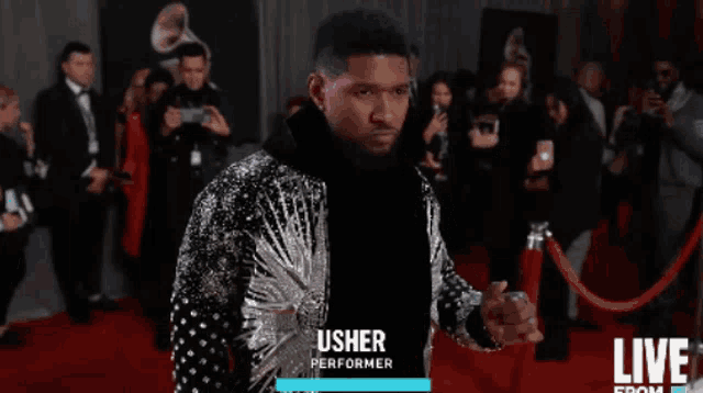 usher performer standing on a red carpet