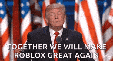 a man in a suit and tie is giving a speech in front of american flags .