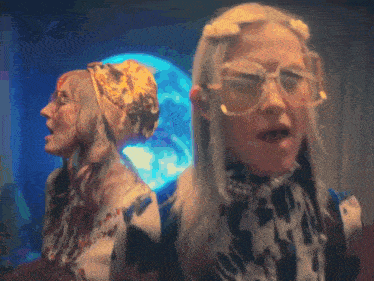 two women are standing next to each other wearing glasses