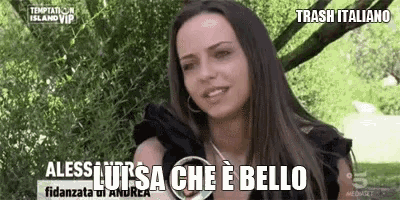 a woman is sitting under a tree with the words trash italiano written above her