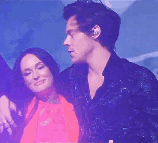 a man and a woman are hugging each other on stage