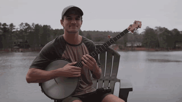 a man sitting on a chair playing a banjo