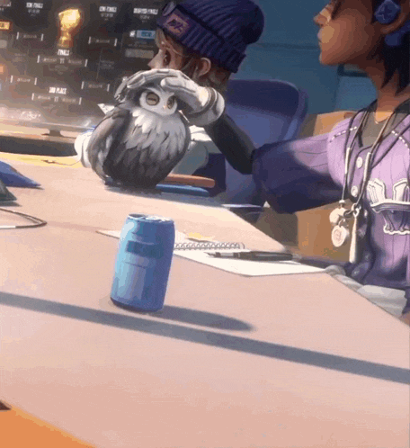 a person in a purple jersey holds an owl over a can of soda