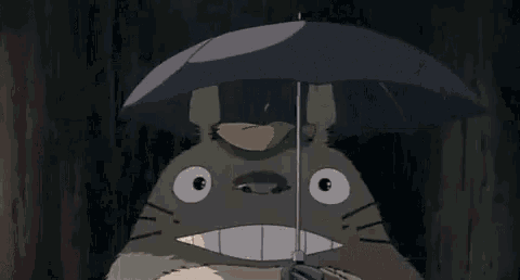 a little girl is holding an umbrella in the rain next to a totoro .