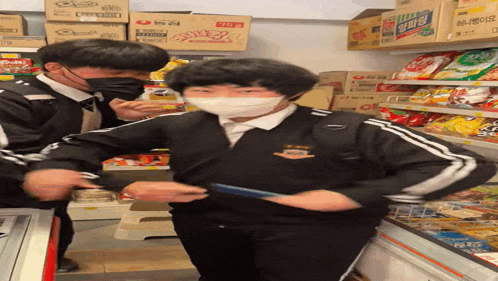 a man wearing a mask is standing in front of a shelf with boxes of noodles