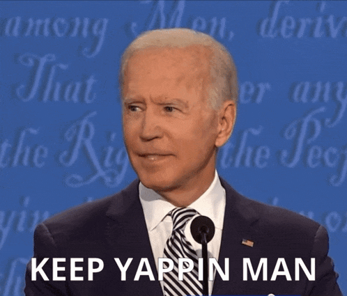 a man in a suit and tie stands in front of a microphone with the words keep yaprin man below him