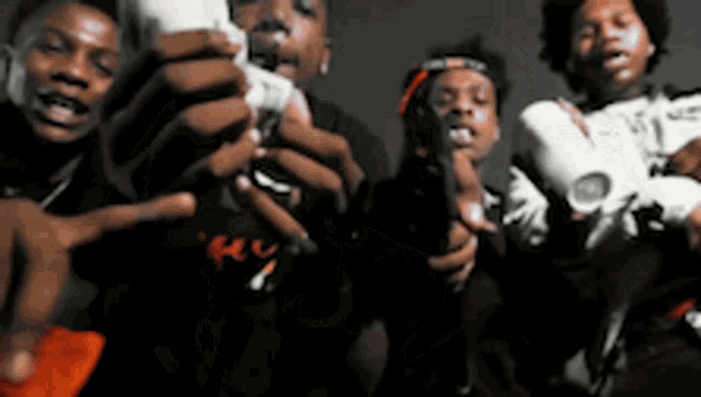 a group of young men are posing for a picture while holding video games