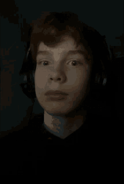 a close up of a person 's face with a hand on it