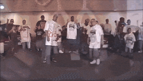 a group of men are standing in a room wearing white shirts that say ' sb ' on them