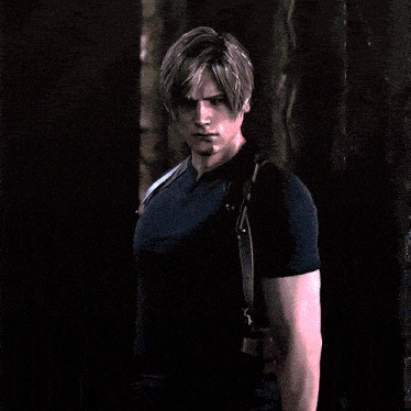 a man wearing a black shirt and gloves is pointing