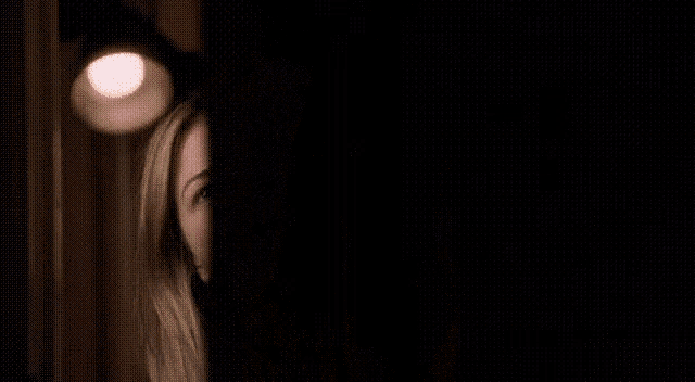 a close up of a woman laughing with her mouth open .