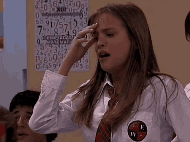 a girl stands in front of a math poster that says olimpiadas de matematica