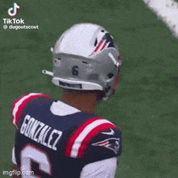 a football player wearing a patriots jersey and helmet