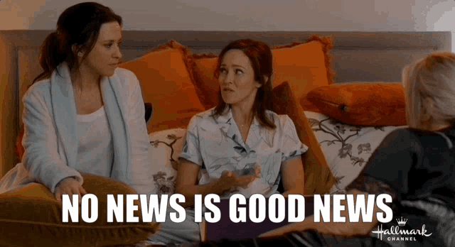 three women are sitting on a bed with the words no news is good news