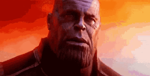 a close up of thanos ' face with a red background