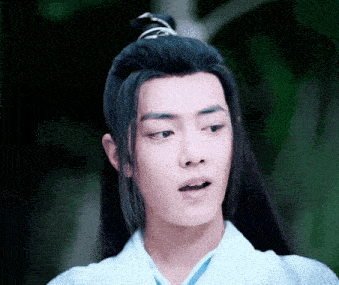 a young man with long black hair is wearing a white kimono .