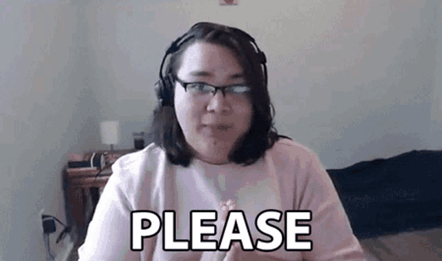 a woman wearing headphones and glasses is talking on a video call and says please .