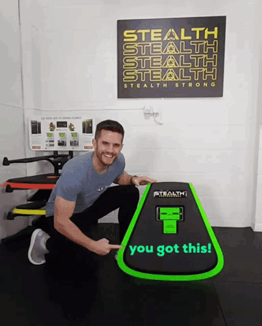 a man kneeling next to a stealth stealth stealth sign