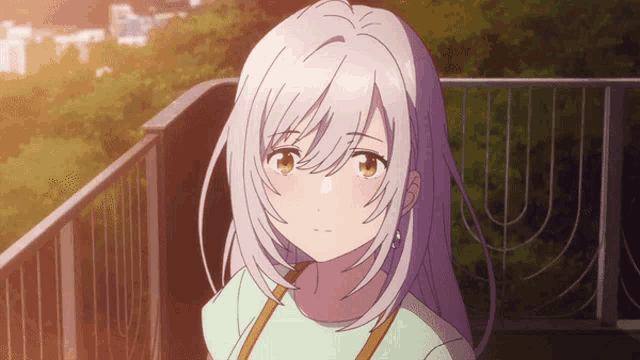 a girl with gray hair and yellow eyes is looking at the camera
