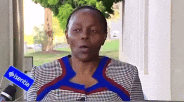 a woman is talking into a microphone with a sign that says ' isentia ' on it