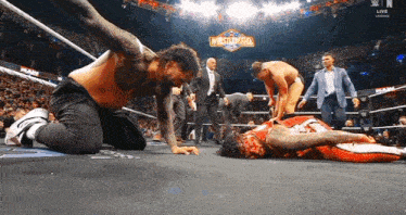 wrestlers in a wrestling ring with a sign that says wrestlemania