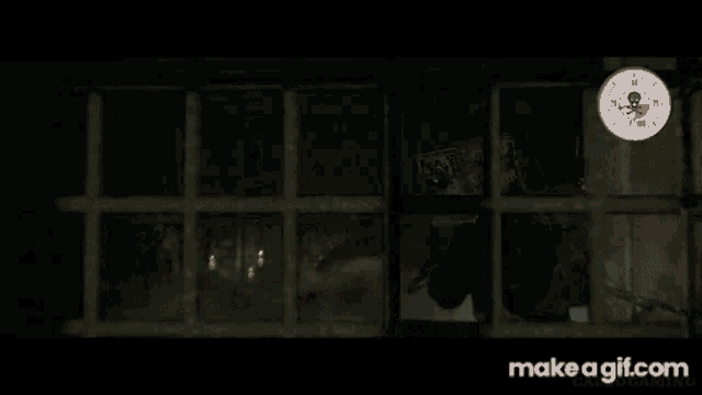 a screenshot of a video game shows a prison cell with blood on the walls