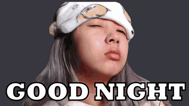 a woman wearing a headband that says good night on it