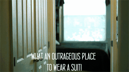 a doorway with the words what an outrageous place to wear a suit on it