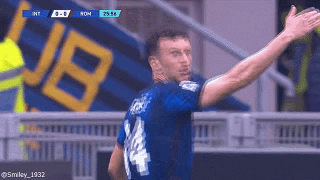 a soccer player in a blue jersey with the number 14 on it