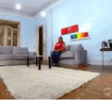 a woman sitting on a couch in a living room
