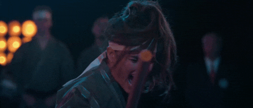 a woman wearing a headband with a c on it