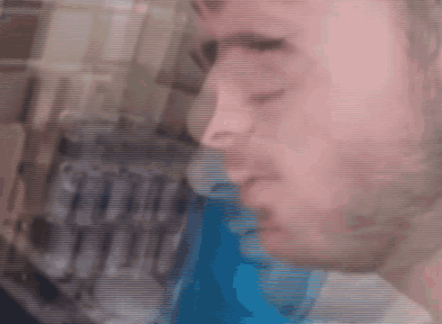 a blurry picture of a man 's face with a blue background