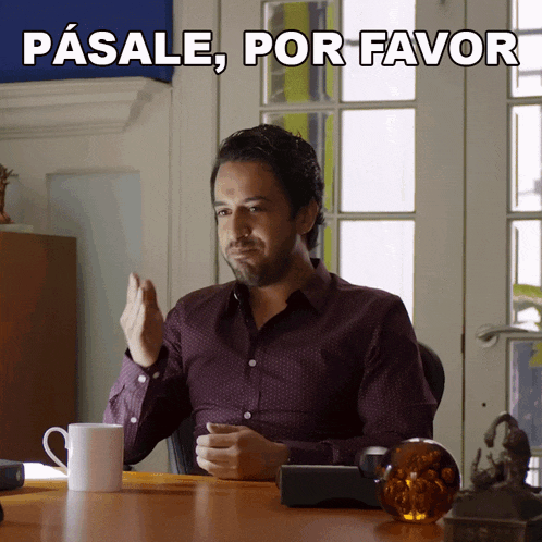 a man sitting at a desk with a cup of coffee and the words pasale por favor above him